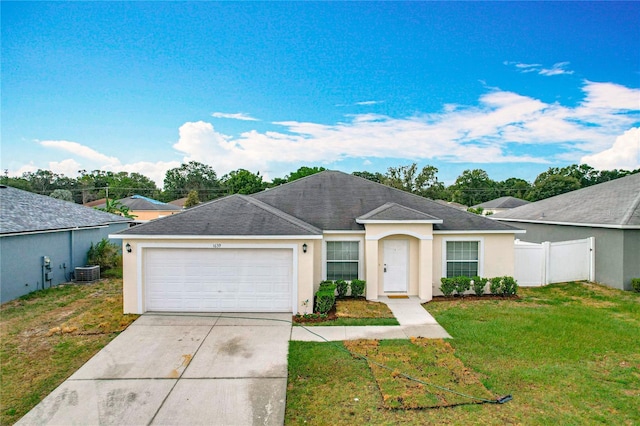 1639 Saddlehorn Dr, Lakeland, FL 33810 - ranch-style home featuring an attached garage, a front lawn, stucco siding, and driveway