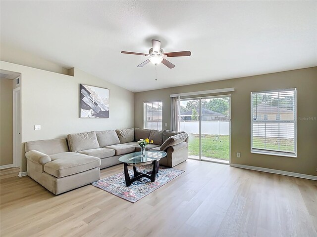1639 Saddlehorn Dr, Lakeland, FL 33810 - living room featuring vaulted ceiling, baseboards, a ceiling fan, and light wood finished floors