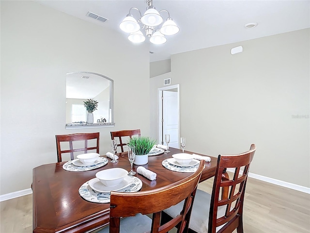1639 Saddlehorn Dr, Lakeland, FL 33810 - dining space with visible vents, baseboards, light wood finished floors, and a chandelier