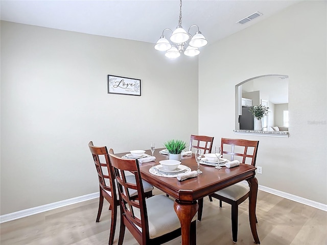 1639 Saddlehorn Dr, Lakeland, FL 33810 - dining room with baseboards, light wood-style floors, a notable chandelier, and visible vents