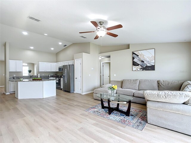 1639 Saddlehorn Dr, Lakeland, FL 33810 - living room featuring a ceiling fan, high vaulted ceiling, visible vents, and light wood-style floors