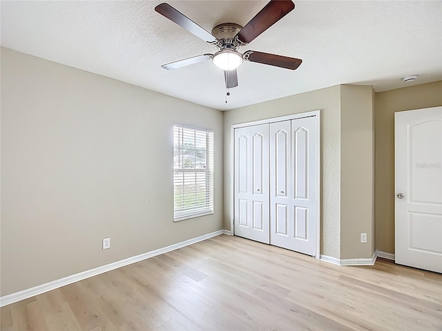 1639 Saddlehorn Dr, Lakeland, FL 33810 - unfurnished bedroom with baseboards, a ceiling fan, a closet, and light wood finished floors