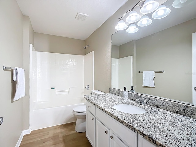 1639 Saddlehorn Dr, Lakeland, FL 33810 - bathroom with visible vents, wood finished floors, vanity, toilet, and bathing tub / shower combination