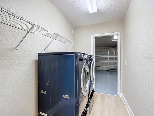 1639 Saddlehorn Dr, Lakeland, FL 33810 - laundry room with laundry area, a textured ceiling, independent washer and dryer, light wood-type flooring, and a textured wall