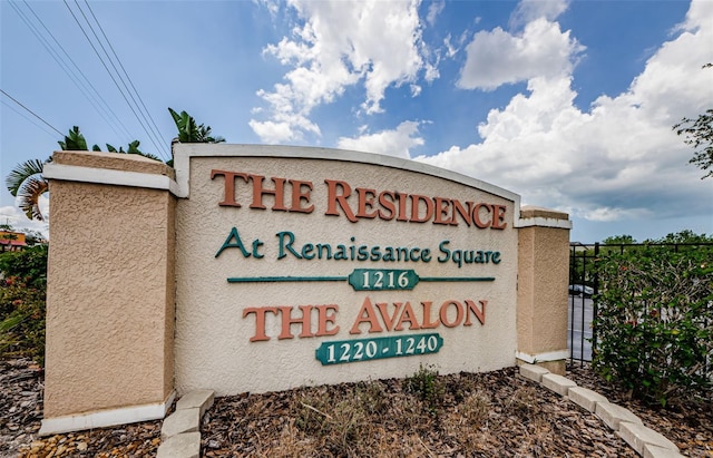 community sign featuring fence