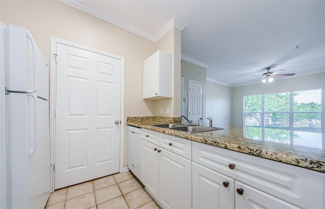 kitchen featuring crown molding, light stone countertops, a sink, white appliances, and white cabinetry