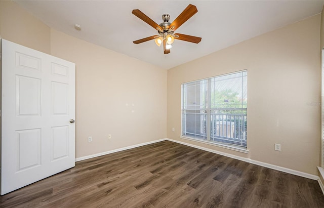 unfurnished room featuring baseboards, ceiling fan, and dark wood-style flooring