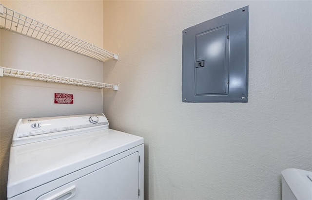 clothes washing area featuring electric panel, washer / clothes dryer, and laundry area