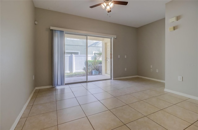 empty room featuring baseboards, ceiling fan, and light tile patterned flooring