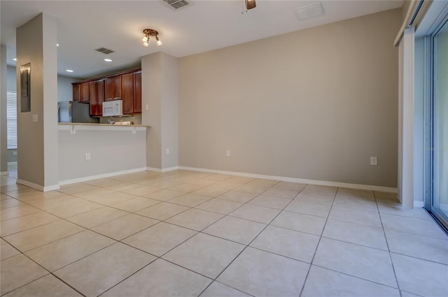 unfurnished living room with light tile patterned floors, electric panel, recessed lighting, and visible vents