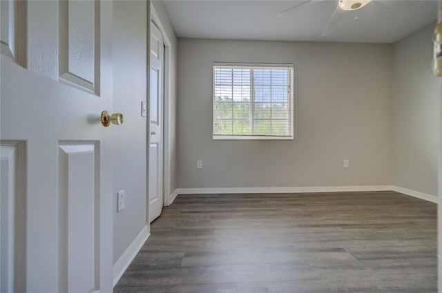 interior space with baseboards, a ceiling fan, and wood finished floors
