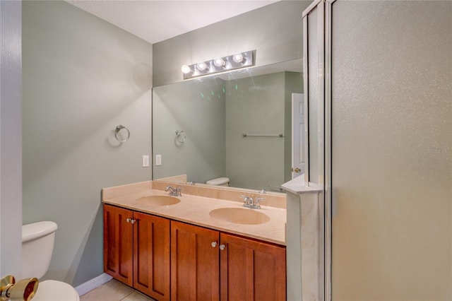 full bath with double vanity, a sink, tile patterned flooring, and toilet