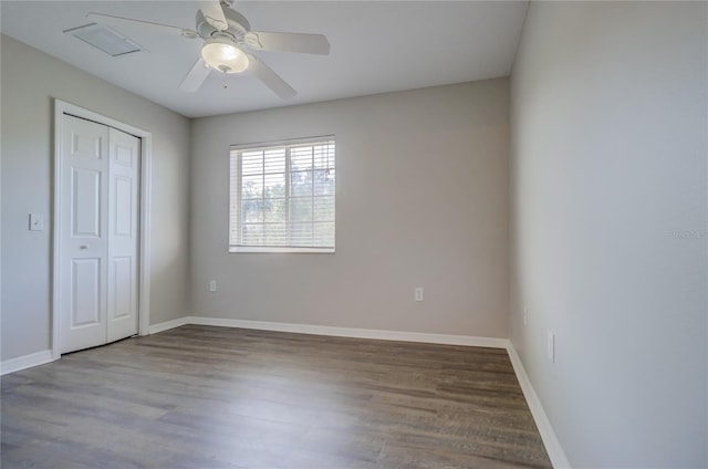 unfurnished bedroom featuring a closet, baseboards, and wood finished floors