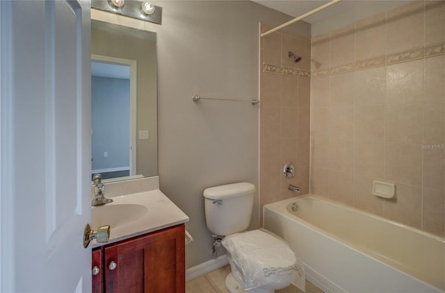 bathroom featuring vanity, baseboards, bathtub / shower combination, and toilet