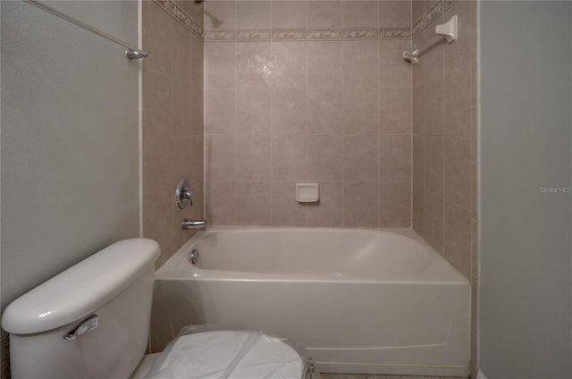 bathroom featuring bathtub / shower combination and toilet