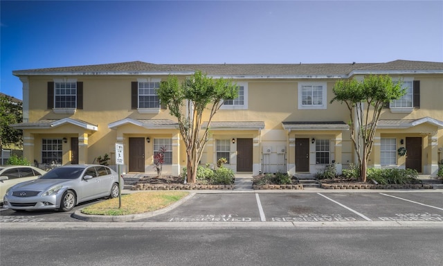 multi unit property with uncovered parking and stucco siding