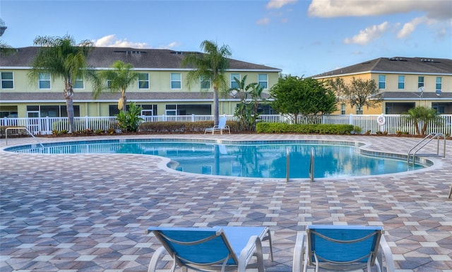 pool featuring a patio and fence