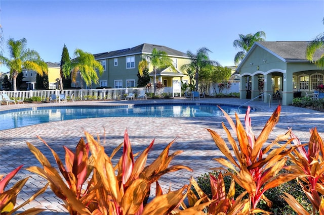pool with fence and a patio