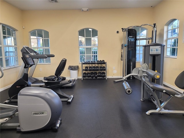 workout area featuring baseboards and plenty of natural light