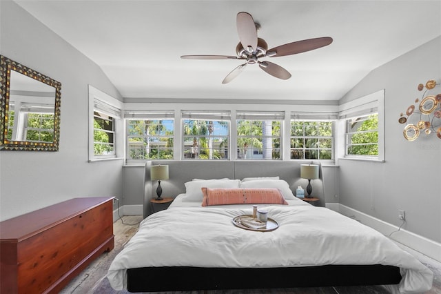 bedroom with baseboards, a ceiling fan, wood finished floors, and vaulted ceiling
