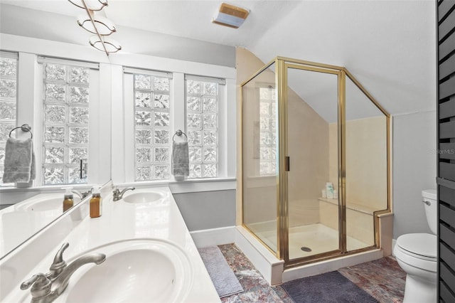 full bath with toilet, a shower stall, and a sink