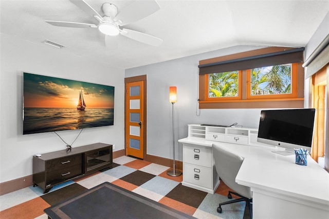 office featuring built in study area, tile patterned floors, a ceiling fan, vaulted ceiling, and visible vents
