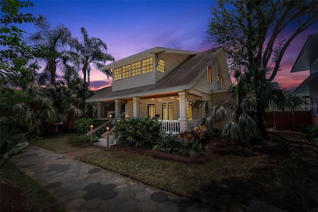 view of front of house featuring fence and a porch