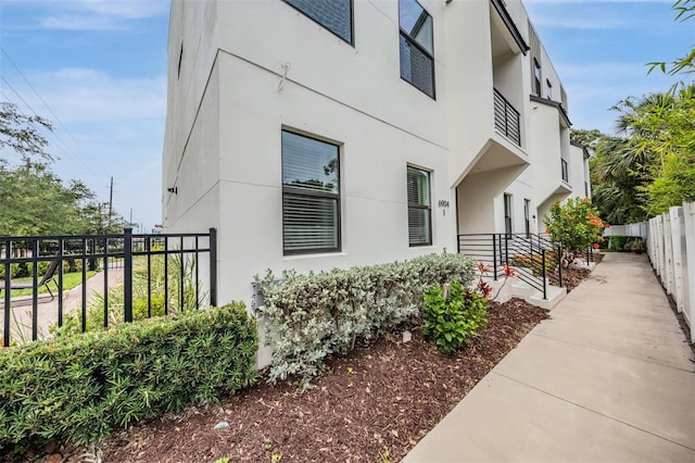 6904 S Macdill Ave Unit 1, Tampa, FL 33611 - view of side of property featuring fence and stucco siding