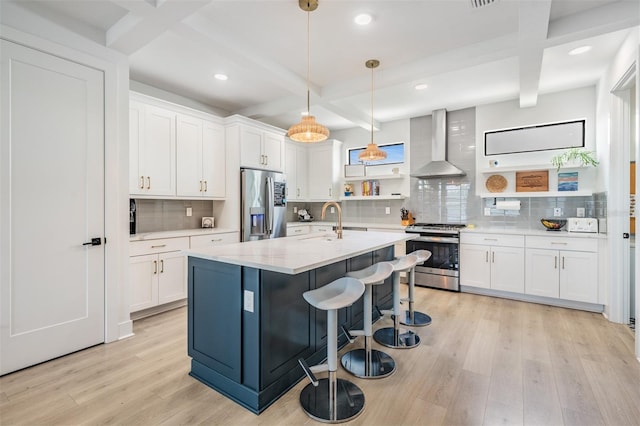 6904 S Macdill Ave Unit 1, Tampa, FL 33611 - kitchen featuring appliances with stainless steel finishes, wall chimney range hood, open shelves, light wood-style floors, and beam ceiling