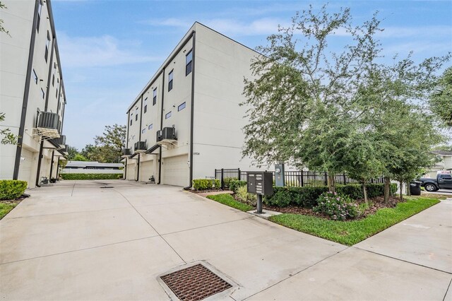 6904 S Macdill Ave Unit 1, Tampa, FL 33611 - view of building exterior with concrete driveway and an attached garage