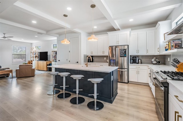 6904 S Macdill Ave Unit 1, Tampa, FL 33611 - kitchen featuring appliances with stainless steel finishes, a sink, beam ceiling, open floor plan, and tasteful backsplash