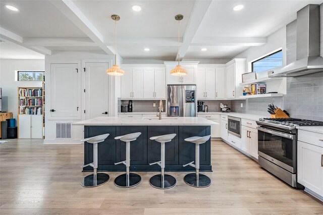 6904 S Macdill Ave Unit 1, Tampa, FL 33611 - kitchen featuring appliances with stainless steel finishes, wall chimney exhaust hood, a sink, coffered ceiling, and tasteful backsplash