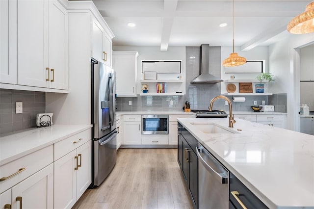 6904 S Macdill Ave Unit 1, Tampa, FL 33611 - kitchen featuring appliances with stainless steel finishes, wall chimney exhaust hood, open shelves, decorative backsplash, and a sink