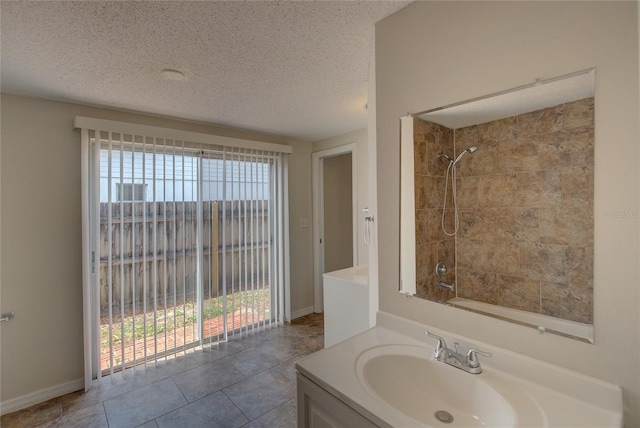 full bathroom featuring a textured ceiling, walk in shower, tile patterned flooring, and vanity