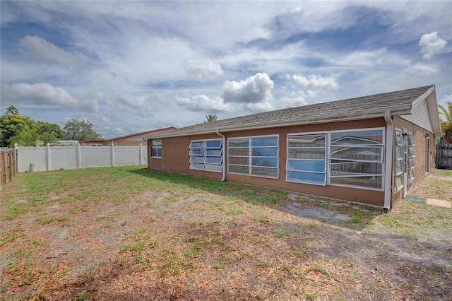 back of house with fence
