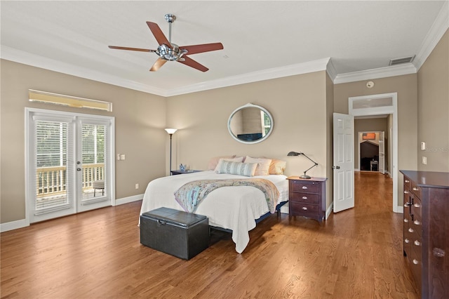 bedroom featuring crown molding, visible vents, wood finished floors, baseboards, and access to outside
