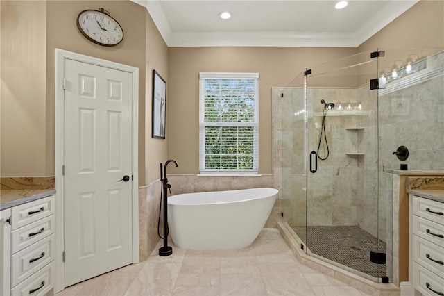bathroom featuring vanity, crown molding, a freestanding tub, recessed lighting, and a stall shower