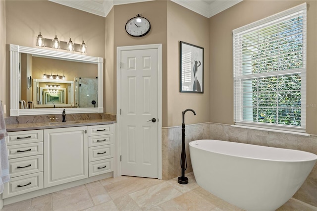 bathroom featuring vanity, ornamental molding, a freestanding tub, tile walls, and a stall shower