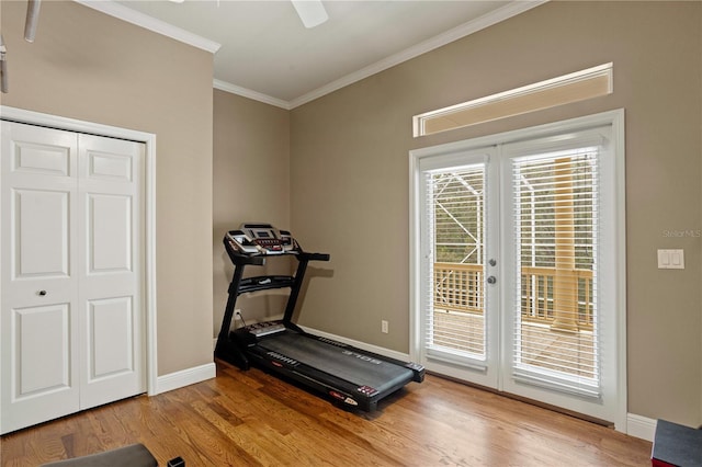 workout area featuring baseboards, ornamental molding, ceiling fan, and wood finished floors