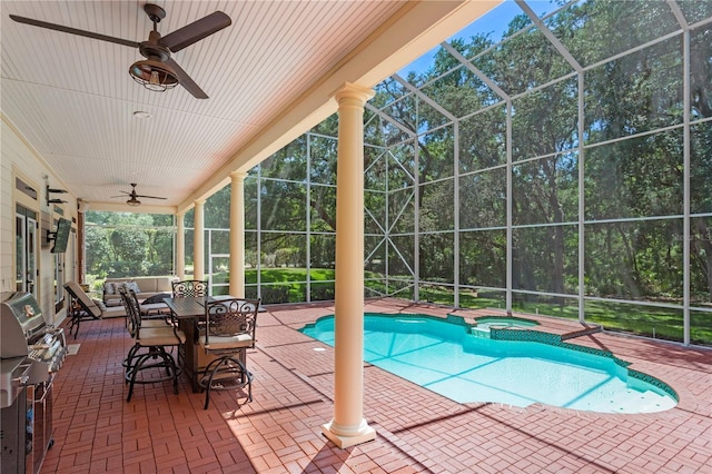 view of swimming pool featuring grilling area, a patio, a ceiling fan, a lanai, and a pool with connected hot tub