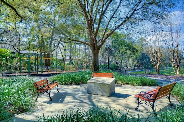 view of property's community with fence and a patio area