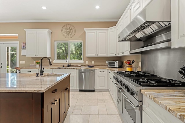 kitchen featuring under cabinet range hood, white cabinets, appliances with stainless steel finishes, and a sink