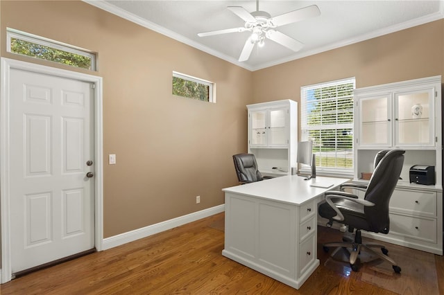 home office featuring crown molding, baseboards, ceiling fan, and wood finished floors