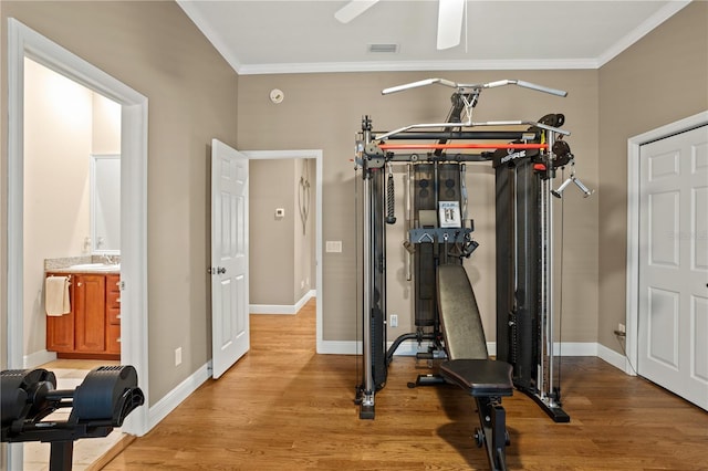 workout room with ornamental molding, a ceiling fan, wood finished floors, and visible vents