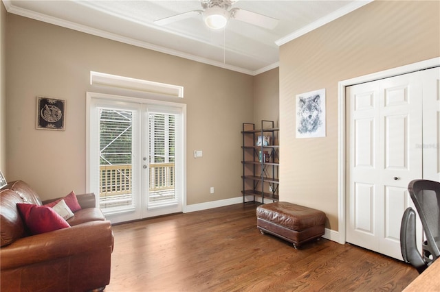 living area with crown molding, wood finished floors, baseboards, ceiling fan, and french doors
