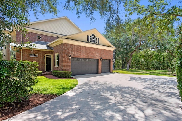 view of front of house featuring brick siding, a front yard, and concrete driveway