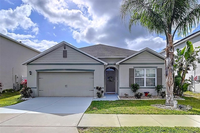3205 Royal Tern Dr, Winter Haven, FL 33881 - ranch-style house with a garage, stucco siding, a front yard, and concrete driveway