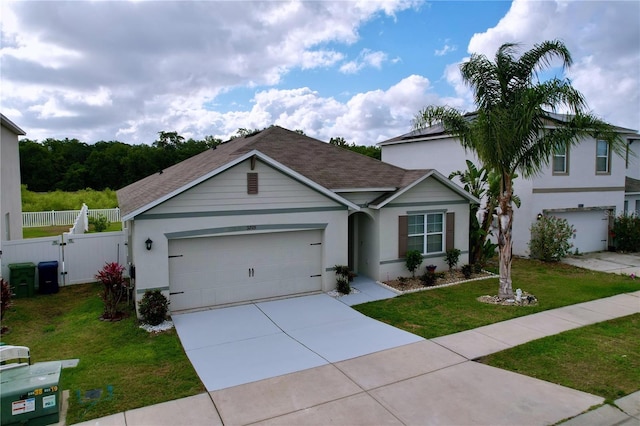 3205 Royal Tern Dr, Winter Haven, FL 33881 - ranch-style home featuring roof with shingles, fence, a front lawn, concrete driveway, and an attached garage