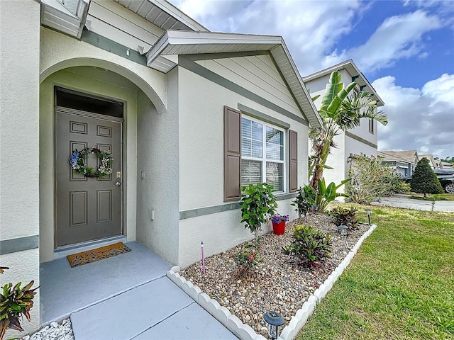 3205 Royal Tern Dr, Winter Haven, FL 33881 - entrance to property featuring a yard and stucco siding