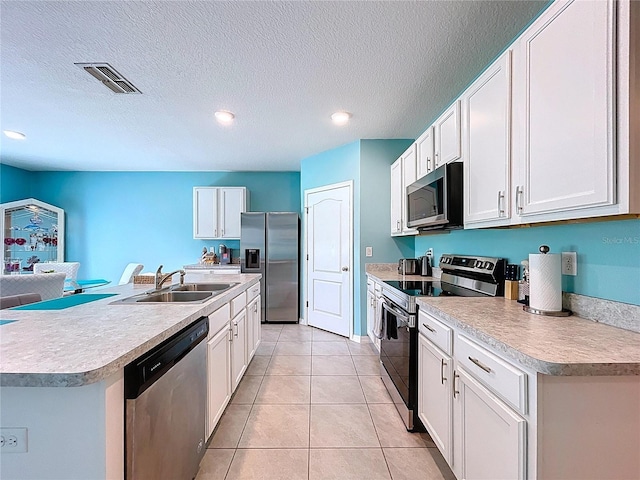 3205 Royal Tern Dr, Winter Haven, FL 33881 - kitchen with visible vents, a sink, light countertops, and stainless steel appliances